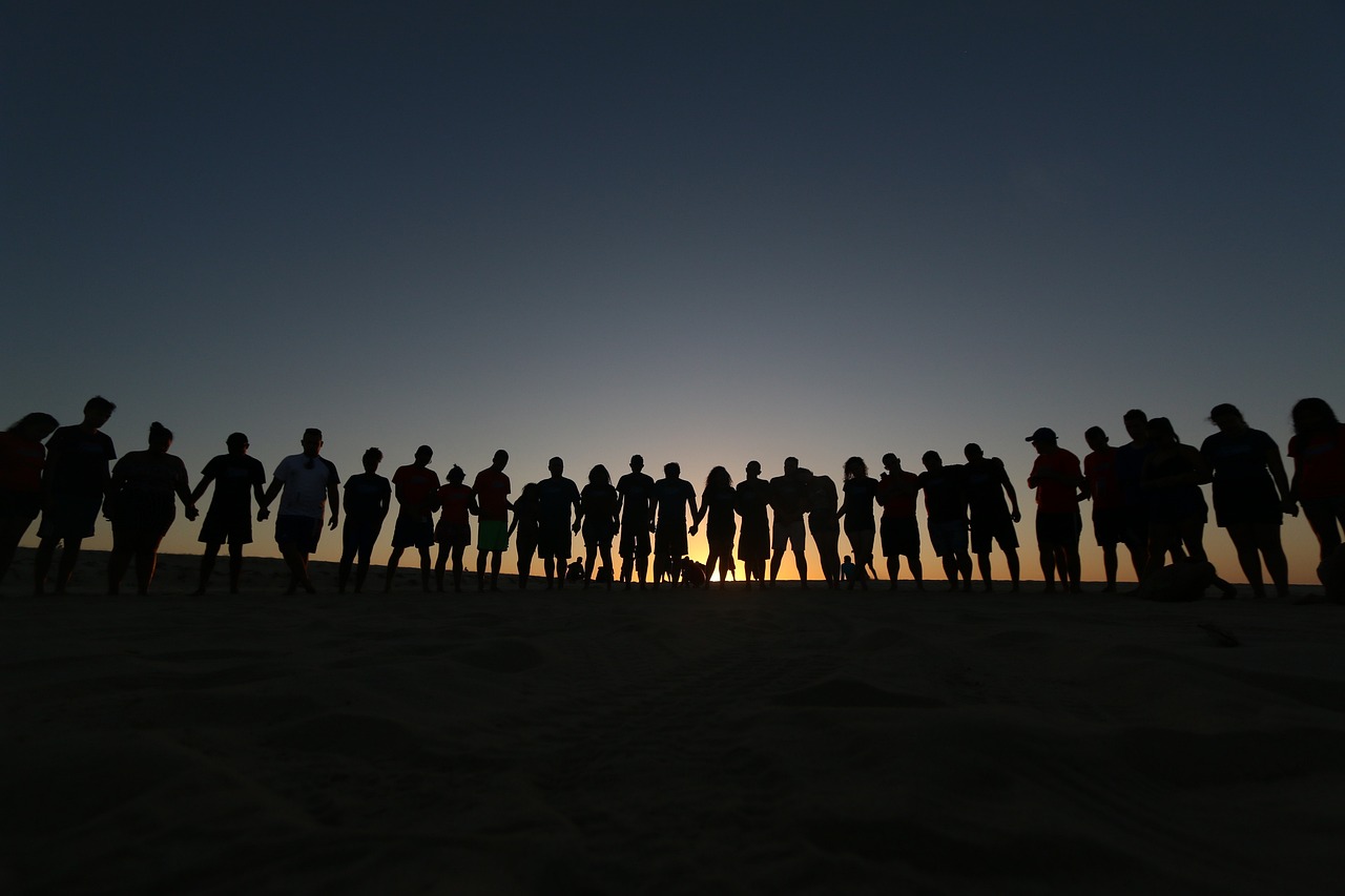 Group of people photographed at sunrise or sunset